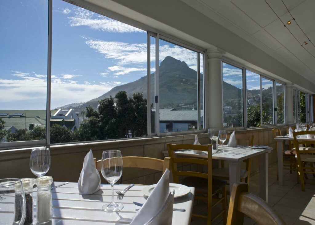 Lion's head seen out the window of this restaurant in Camps Bay, providing a stunning backdrop to the seafood feast