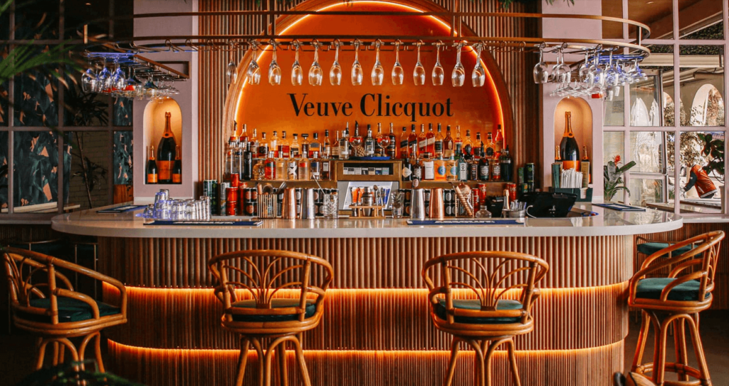 The bar at this stylish restaurant in Camps Bay, featuring cane bar stools and finishes, and a well stocked selection of beverages