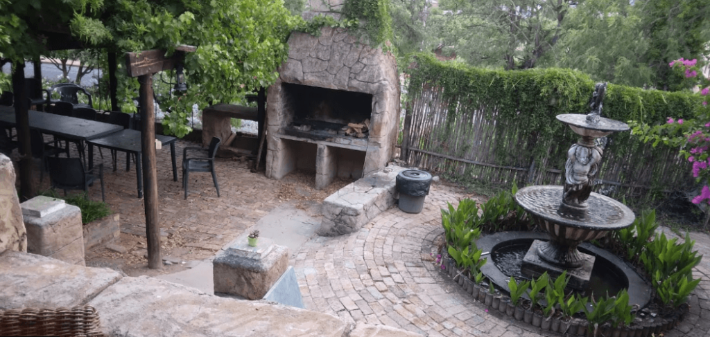 The beautiful braai area and gardens of this Malmesbury accommodation, featuring a stunning fountain