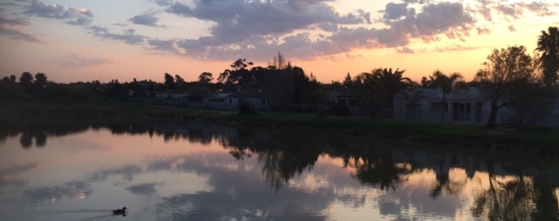 The sun setting over the Uitzicht Greenbelt Body of Water a easily accessible spot for fishing in Cape Town