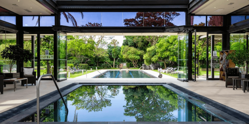 Many Western Cape hotels feature stunning swimming pools to help guests relax and cool off, like this one at The Vineyard which features both an indoor and outdoor pool