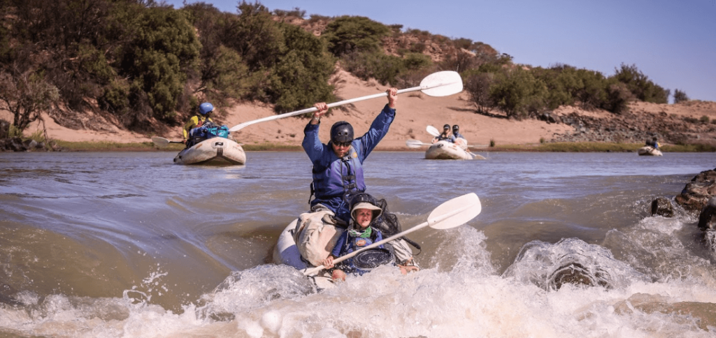 Two people going through some rapids, an example of the white river rafting Western Cape has to offer